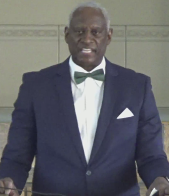 A person in a suit and bow tie standing at a podium

AI-generated content may be incorrect.