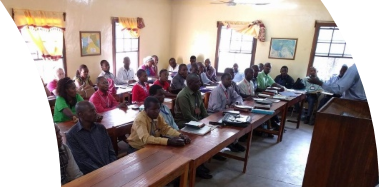 A group of people sitting at desks in a room
Description automatically generated with medium confidence